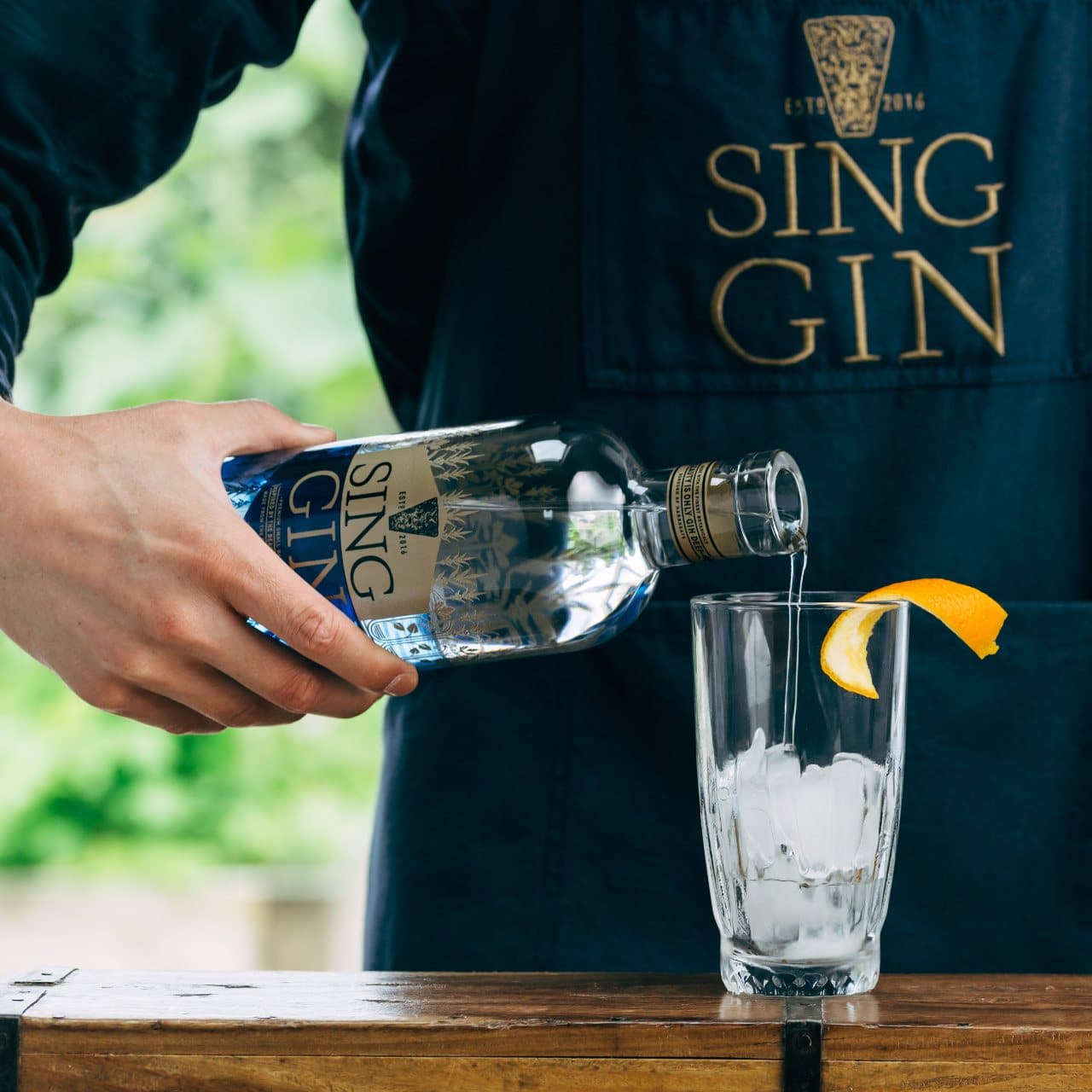 Pouring sing gin into a glass