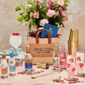 A bottle of gin, mixers, and jute bag